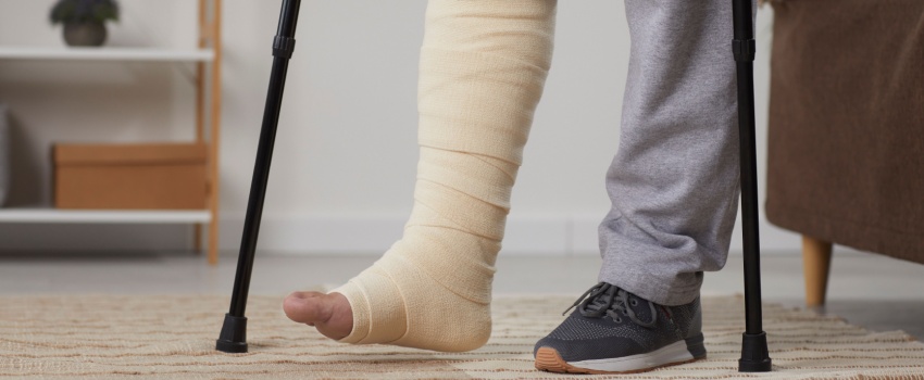 A man with a broken leg using crutches.