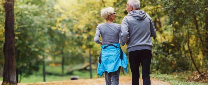 A couple jogging in a park.